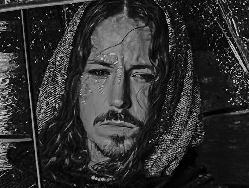 Michał Szpak w awangardowym stroju scenicznym, z intensywnym spojrzeniem i charakterystycznym makijażem.